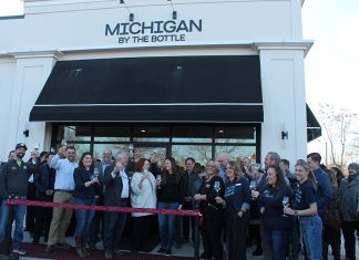 Owners, staff, and guests celebrating the opening of the new Michigan by the Bottle location in Lake Orion.